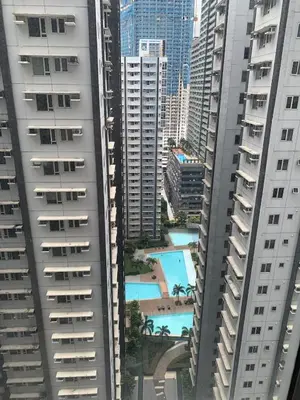 an aerial view of a pool between two buildings at Fame Tower 2 Luxury Queen with own Washer in Manila