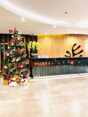 a christmas tree in a hotel lobby with a christmas tree at S Suite Home MOA Staycation in Manila
