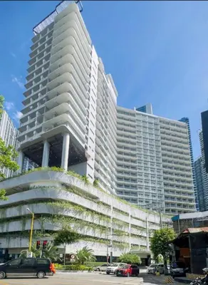 a large white building with cars parked in front of it at Lush Residences 1Br Haven Suite Makati Smart TV Netflix Hi speed internet in Manila