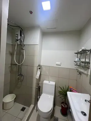 a bathroom with a toilet and a shower and a sink at Key and Stay in Manila
