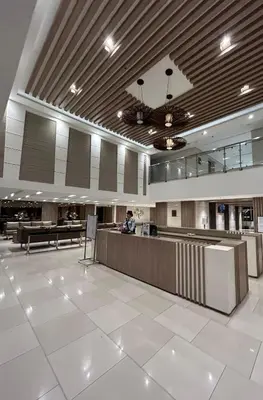 a large lobby with a reception desk in a building at Key and Stay in Manila