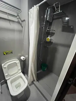 a small bathroom with a toilet and a shower at Affordable Staycation Home in Makati in Manila