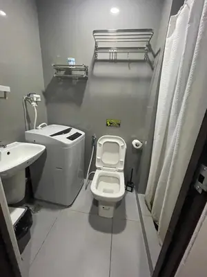 a small bathroom with a toilet and a sink at Affordable Staycation Home in Makati in Manila