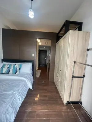 a bedroom with a large bed and a wooden wall at Affordable Staycation Home in Makati in Manila