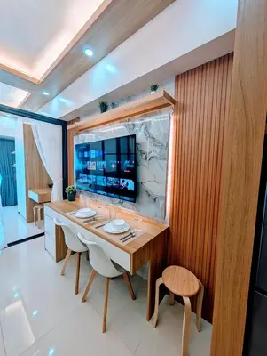 a dining room with a large wooden table and chairs at Cozy Modern Sunset View in Manila