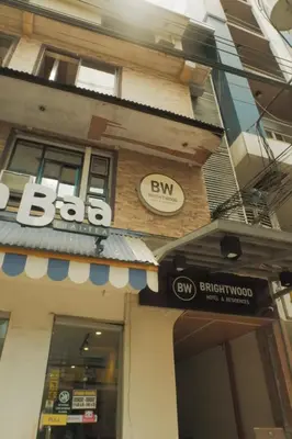 a building with aba sign on the side of it at Brightwood Hotel & Residences in Manila