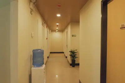 a hallway of a hospital with a blue barrel at Brightwood Hotel & Residences in Manila