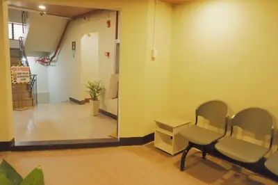 a waiting room with a chair and a table at Brightwood Hotel & Residences in Manila