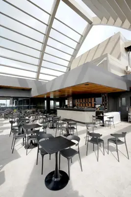 a cafeteria with tables and chairs in a building at Cedrosa Lofts GA Tower in Manila