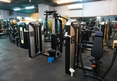 a gym with rows of treadmills and machines at Cedrosa Lofts GA Tower in Manila