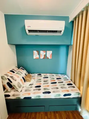 a bedroom with a bed with a air conditioner at Cedrosa Lofts GA Tower in Manila