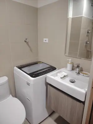 a small white bathroom with a stove and a toilet at Shore 3 Tower 30372 in Manila