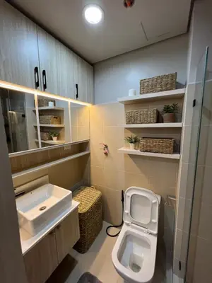 a bathroom with a sink and a toilet in it at Cozy Condo Apartment in Red Residences Makati near malls and airport in Manila