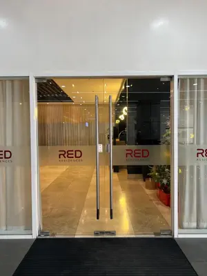 an open glass door of a red manufacturer store at Cozy Condo Apartment in Red Residences Makati near malls and airport in Manila
