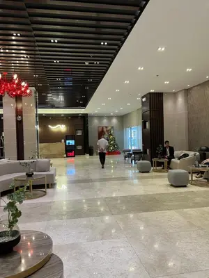 a person walking through a lobby of a hotel at Cozy Condo Apartment in Red Residences Makati near malls and airport in Manila
