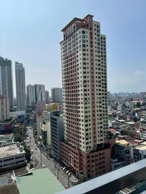 a tall building in the middle of a city at Cozy Condo Apartment in Red Residences Makati near malls and airport in Manila