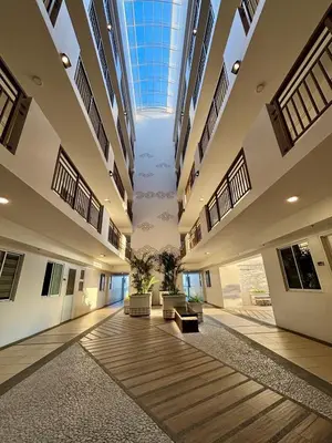 an empty lobby with a skylight in a building at Metro Zen at DMCI Satori Residence 1br in Manila