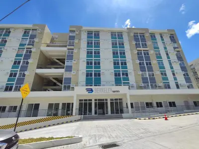 a large building with a parking lot in front of it at Sweet, Simple and Stylish Studio in Silang