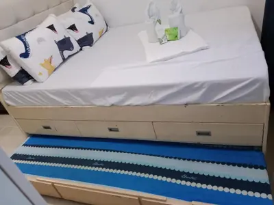 a bed with white sheets and pillows on it at Sea Residence Tower EF Lets in Manila