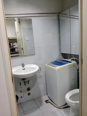 a small bathroom with a toilet and a sink at Sea Residence Tower EF Lets in Manila