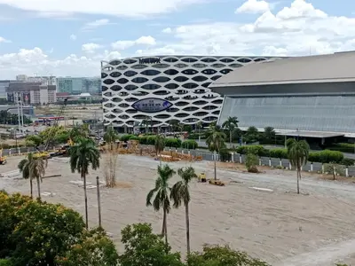 a large building with palm trees in front of it at Sea Residence Tower EF Lets in Manila