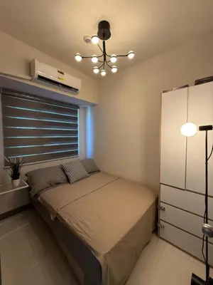 a bedroom with a bed and a window at Coastresidences by Rinseiki in Manila