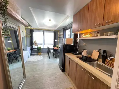 a kitchen with a sink and a counter top at Stylish unit in Ortigas near podium & holiday inn in Manila