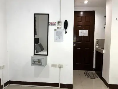 a room with a mirror and a door at Harrison Suites in Manila