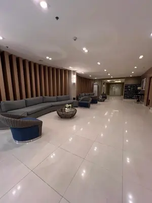 a lobby with couches and a table in a building at Sea Residence MOA Prime by Paul in Manila