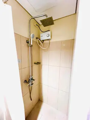 a shower in a bathroom with a shower head at Sea Residence MOA Prime by Paul in Manila