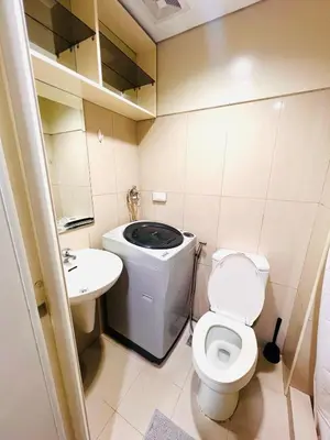 a small bathroom with a toilet and a sink at Sea Residence MOA Prime by Paul in Manila