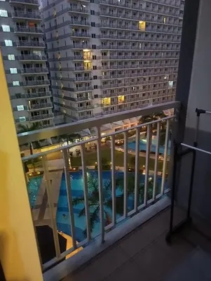 a view from the balcony of a condo at night at Shell Residences By Jhem Place in Manila