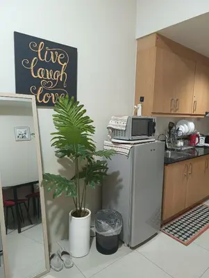 a kitchen with a refrigerator and a microwave at Shell Residences By Jhem Place in Manila
