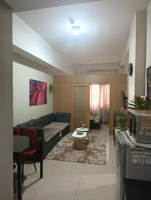 a living room with a couch and a table at Shell Residences By Jhem Place in Manila