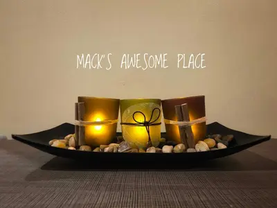 a plate with candles and rocks on a table at CUBAO Macks Awesome Place NETFLIX UNLIFAST WIFI in Manila