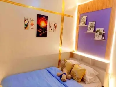 a bedroom with a bed with a stuffed animal on it at Shore3 Residences Tower2 Staycation in Manila