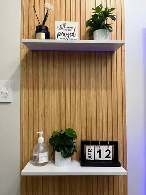 a shelf with potted plants and a clock on it at Shore3 Residences Tower2 Staycation in Manila