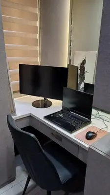 a desk with a laptop and a computer monitor at 2 BR, 2 Full Bathrooms, with hotel feels and a jet tub in Manila