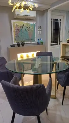a glass table with chairs in a living room at 2 BR, 2 Full Bathrooms, with hotel feels and a jet tub in Manila