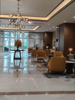 a lobby with chairs and a table in a building at Condo Suite 1 Bedroom McKinley West Taguig City in Manila