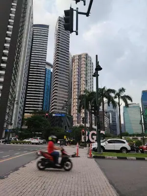 a person riding a motorcycle on a city street at Condo Suite 1 Bedroom McKinley West Taguig City in Manila