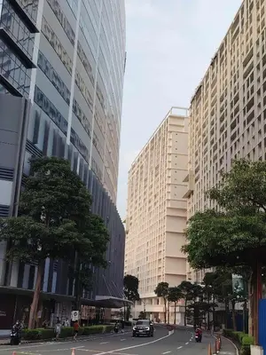 a city street with two tall buildings and trees at Condo Suite 1 Bedroom McKinley West Taguig City in Manila
