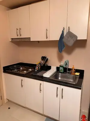 a kitchen with a sink and a counter top at The Essential 2 BR at Sm Jazz makati 100 mbps in Manila