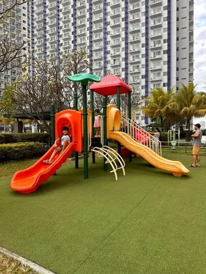 a playground with two slides and a slideintend at The Essential 2 BR at Sm Jazz makati 100 mbps in Manila