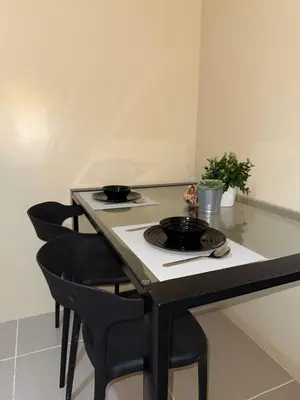 a table with two plates on top of it at Spacious pool view at Mall of Asia 100mb Netflix in Manila
