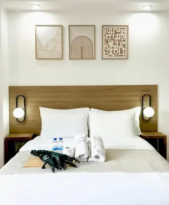 a bed with two towels and two bottles of water on it at Exquisite Japandi 2 & Mediterranean Breeze at Venice w Grand Canal View! in Manila