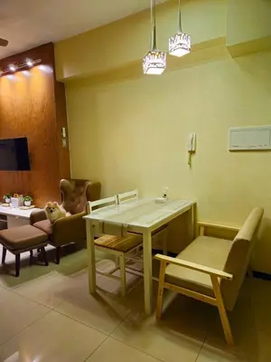a waiting room with a table and chairs at Galini Suites in Manila