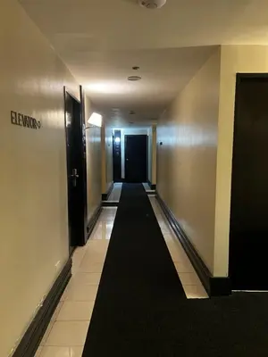 a hallway with a long black carpet in a building at Hotel Sogo EDSA Shaw Blvd in Manila