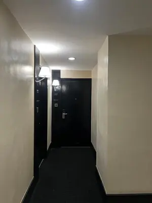 a hallway with a black door in a building at Hotel Sogo EDSA Shaw Blvd in Manila