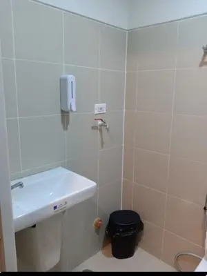a bathroom with a sink and a toilet at One Bedroom Unit in Fame Residences in Manila